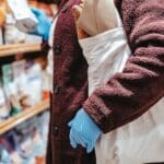 Woman with shopping bag choosing food in supermarket