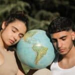 A Couple Head's Leaning on a Globe