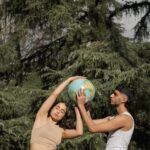 A Man and a Woman Holding a Globe