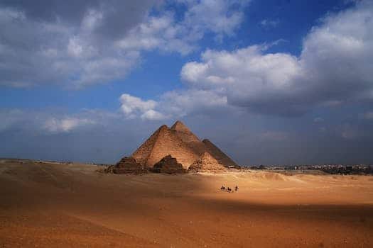 Amazing view of sandy dunes in desert with Pyramid of Cheops in Egypt