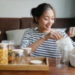 Asian woman opening environmentally friendly bag of pasta