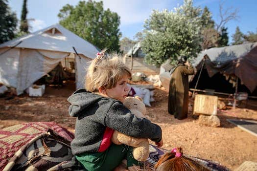 Cute girl with toy in refugee camp