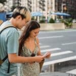 Traveling couple standing on sidewalk with map